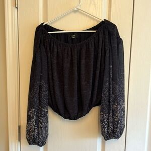 Off-the-shoulder dark blue top with floral design on sleeves